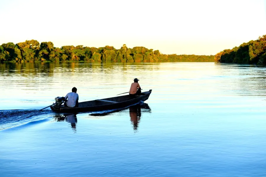two men on a boat on the Amazon river